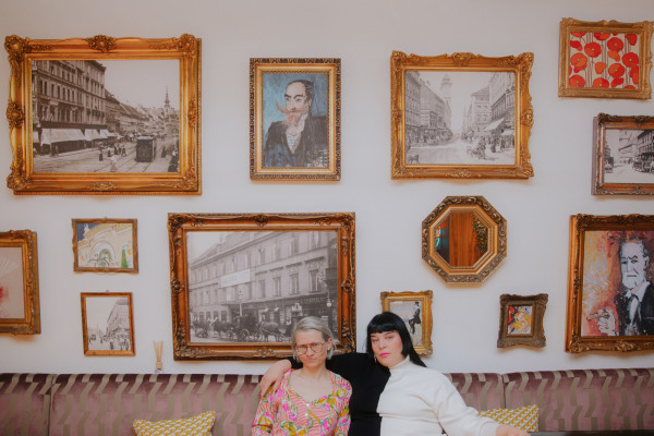 Two women in front of the picture wall at Hotel Schani Salon