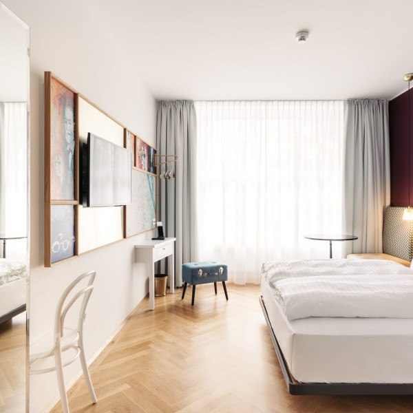 Bright room with a large window in the boutique Hotel Schani Salon in central vienna