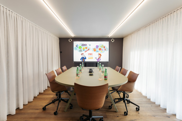 Prepared meeting table in meeting room with enough space for up to 8 people